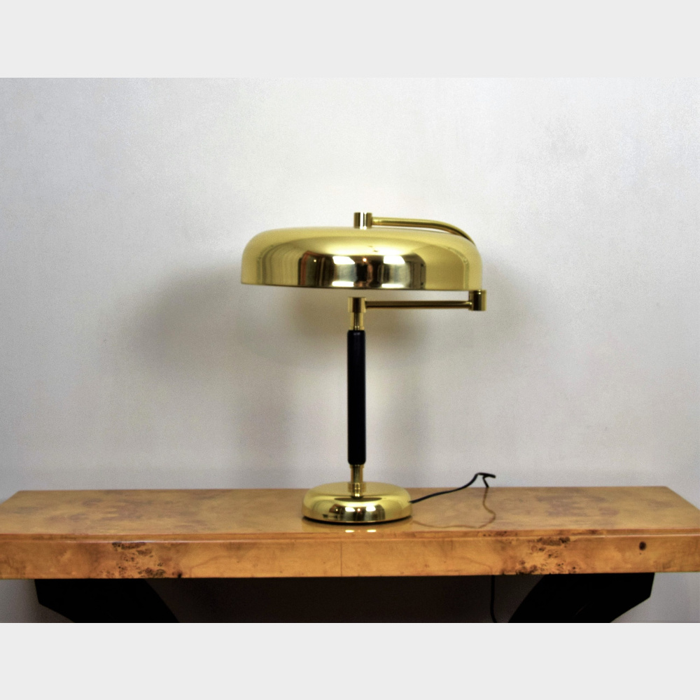 Desk lamp type Desny in glossy lacquered brass and stem in black lacquered wood, diffuser articulated on its arm. Lampada da scrivania tipo Desny
